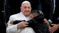 Paus Fransiskus memberkati seorang anak di akhir audiensi umum mingguan di Lapangan Santo Petrus, Vatikan, pada 6 Maret 2024. Massimo Valicchia/NurPhoto via Getty Images