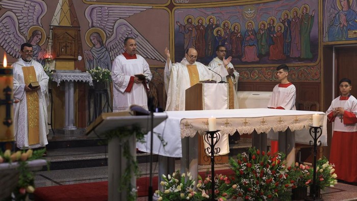 Members of the clergy stand during a Mass at the Holy Family Church after the death of Pope Francis was announced by the Vatican, in Gaza City, April 21, 2025. REUTERS/Dawoud Abu Alkas