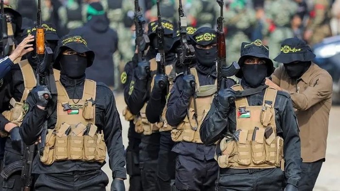 Palestinian Islamic Jihad militants stand guard before the handover of hostages who had been held in Gaza since the deadly October 7, 2023 attack, to members of the International Committee of the Red Cross (ICRC) as part of a ceasefire and a hostages-prisoners swap deal between Hamas and Israel, in Gaza City, January 25, 2025. (Reuters)