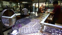 Pedagang menunjukkan emas Antam di etalase toko kawasan Cikini, Jakarta, Rabu (23/4/2025).