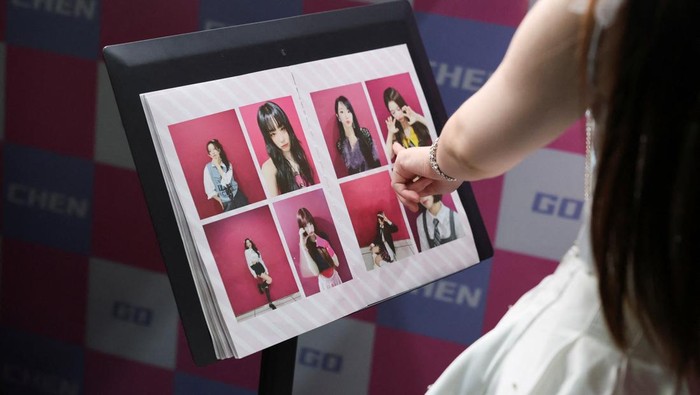 Visitors prepare to take photos in costumes at Chen Go, an 