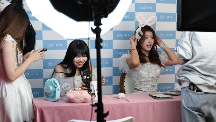 Visitors prepare to take photos in costumes at Chen Go, an 