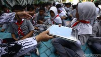 Siswa menerima menu makan bergizi gratis di SDN Jurang Mangu Timur 02, Tangerang Selatan, Banten, Selasa (25/4/2025).