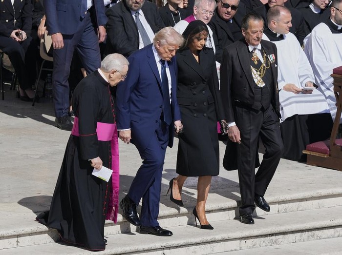 President Donald Trump and first lady Melania Trump, center, arrive for the funeral of Pope Francis in St. Peters Square at the Vatican, Saturday, April 26, 2025. (AP Photo/Gregorio Borgia)