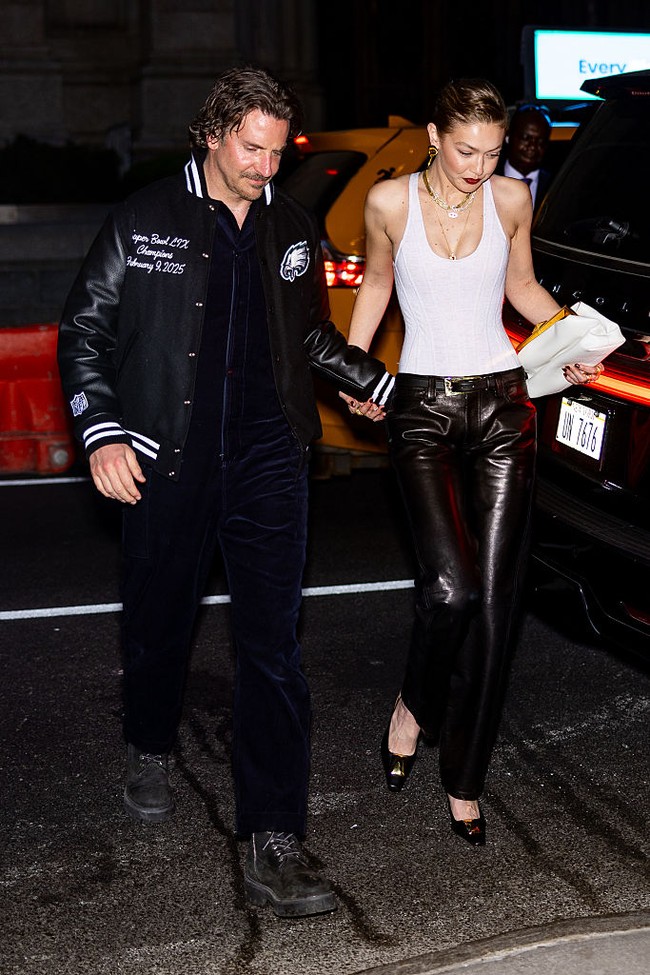 Untuk pesta yang turut dihadiri sang kakak, model Bella Hadid, aktris Anne Hathaway, dan model Anok Yai, gayanya sederhana tapi memukau dengan tanktop putih ketat dan celana kulit hitam. Ia kemudian melengkapi gayanya dengan heels hitam dan clutch putih senada. Bradley menyelaraskan gayanya dalam balutan busana serba hitam, dengan jaket varsity sebagai luaran. (Foto: The Hapa Blonde/GC Images)