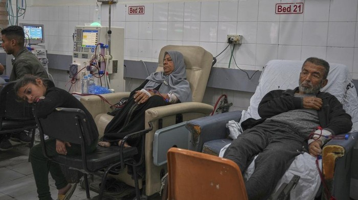 Wasem Attiya pushes his father, Mohamed, 54, in a wheelchair as they head to Shifa hospital in Gaza City for a dialysis session, Monday, April 14, 2025. (AP Photo/Jehad Alshrafi)