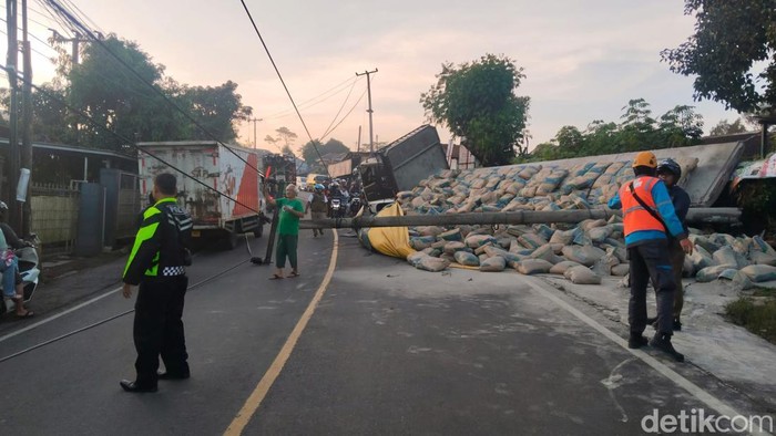 Truk dan ratusan semen sempat berserakan di jalan