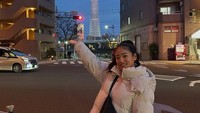 Gaya fotonya dengan latar Tokyo Skytree.