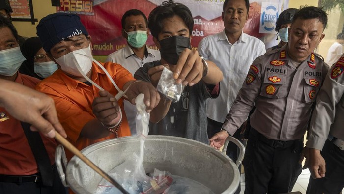 Dua orang tersangka pengedar menuangkan sabu ke dalam panci saat pemusnahan barang bukti di Mapolresta Palu, Sulawesi Tengah, Senin (28/4/2025). Polresta Palu memusnahkan barang bukti narkotika jenis sabu seberat 1,7 kilogram yang disita dari dua tersangka pengedar. ANTARA FOTO/Basri Marzuki/rwa.