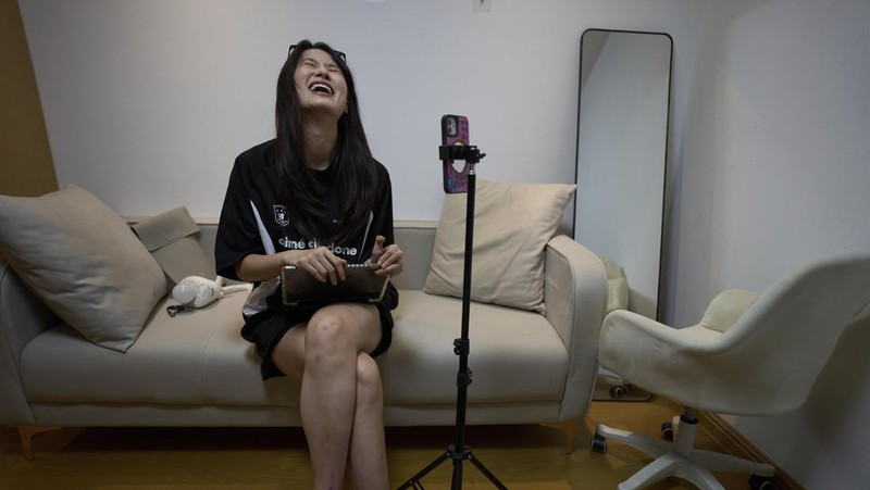 Tian Xin, a cyber matchmaker, hosts a livestream using the Chinese social media app Xiaohongshu (RedNote) from Hangzhou, China, early Friday, April 25, 2025. (AP Photo/Ng Han Guan)