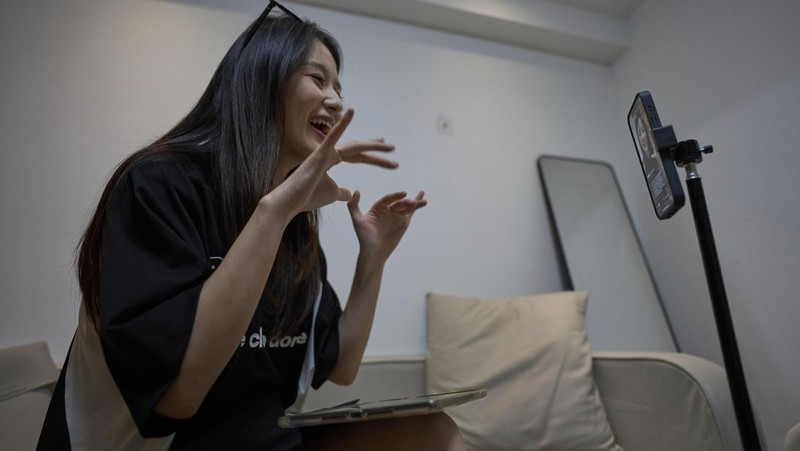 Tian Xin, a cyber matchmaker, hosts a livestream using the Chinese social media app Xiaohongshu (RedNote) from Hangzhou, China, early Friday, April 25, 2025. (AP Photo/Ng Han Guan)