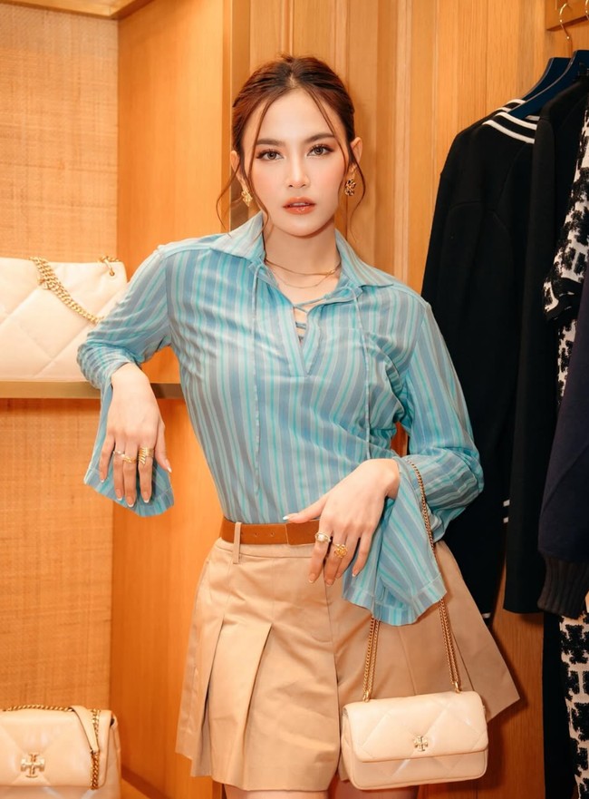 Gayanya kembali terlihat bak ABG dengan memadukan kemeja biru dengan rok celana pendek warna coklat. Ia kemudian melengkapi penampiilannya dengan ikat pinggang coklat serta beberapa aksesori seperrti anting, kalung, dan cincin warna emas. Foto: Instagram/@mahaliniraharja