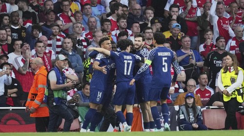 PSG players celebrate after Ousmane Dembele scored the opening goal during the Champions League semifinal first leg soccer match between Arsenal and Paris Saint-Germain at Arsenal Stadium in London, England, Tuesday, April 29, 2025. (AP Photo/Kin Cheung)