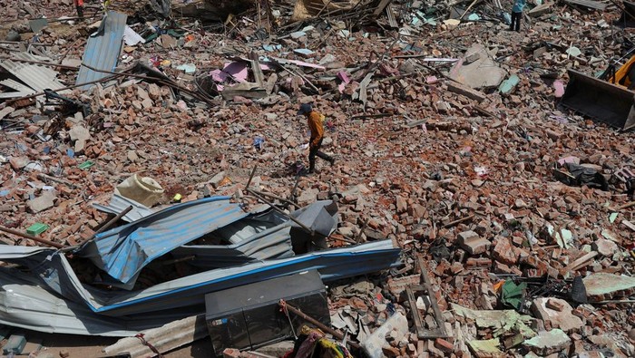 Bulldozers queue next to the debris of houses that were demolished during a demolition drive by the authorities at a slum in Chandola Lake, Ahmedabad, India April 29, 2025. REUTERS/Amit Dave