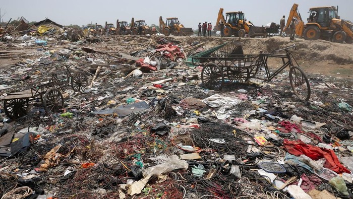 Bulldozers queue next to the debris of houses that were demolished during a demolition drive by the authorities at a slum in Chandola Lake, Ahmedabad, India April 29, 2025. REUTERS/Amit Dave