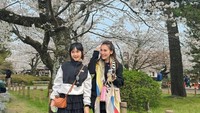 Bukan hanya berfoto dengan latar pohon sakura saja. Ayu dan keluarga juga eksplor Jepang salah satunya ke Disneyland. (Instagram/Ayutingting92)