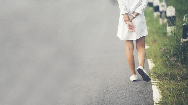 Banner Woman traveller walking on road relaxation. Women wear sneaker shoes walking summer park. Females standing green park on forest pathway outdoors. Traveler relaxing walk way with copy space