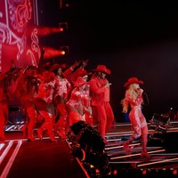 Dalam salah satu segmen paling playful, Beyoncé tampil mengenakan catsuit bermotif kemeja koboi dengan print bandana merah-putih, rancangan Moschino. Motif bandana ini adalah simbol ikonis dalam budaya koboi dan musik country, tapi rumah mode Italia itu mengemasnya ulang dalam gaya khas mereka yang teatrikal, ironis, dan sangat fashion-forward. (Foto: Instagram/@beyonce)