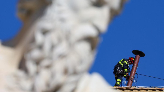 Firefighters work to set a chimney on the roof of the Sistine Chapel, ahead of the conclave, at the Vatican May 2, 2025. REUTERS/Guglielmo Mangiapane     TPX IMAGES OF THE DAY
