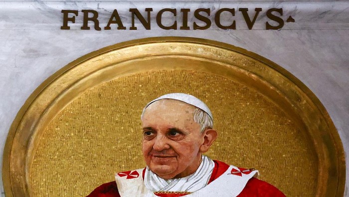 A person takes a picture of mosaic depicting various popes, including the late Pope Francis inside the Basilica of Saint Paul Outside the Walls, alongside an empty space reserved for the next pope to be elected in the forthcoming conclave, in Rome, Italy, May 1, 2025. REUTERS/Yara Nardi