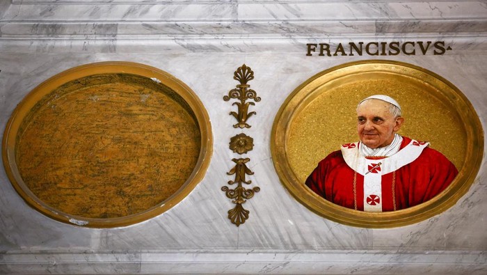 A person takes a picture of mosaic depicting various popes, including the late Pope Francis inside the Basilica of Saint Paul Outside the Walls, alongside an empty space reserved for the next pope to be elected in the forthcoming conclave, in Rome, Italy, May 1, 2025. REUTERS/Yara Nardi
