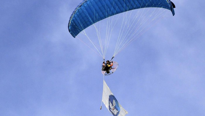 Seorang atlet dari komunitas paralayang Cyloop Flying Club mengibarkan logo pendidikan dalam upacara peringatan Hari Pendidikan Nasional 2025 di Halaman, Kantor Gubernur Provinsi Papua, Kota Jayapura, Jumat (2/5/2025). Peringatan Hari Pendidikan Nasional 2025 tersebut bertema Partisipasi Semesta Mewujudkan Pendidikan Bermutu Untuk Semua. ANTARA FOTO/Gusti Tanati/nym.