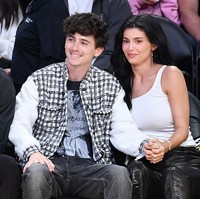 Tampil serasi, Timothee dan Kylie mengenakan busana bernuansa monokrom. Aktor ‘Dune’ tersebut tampak memakai T-shirt putih lengan panjang bergambar Kobe Bryant, dipadu jeans hitam dan vest motif gingham. Foto: Getty Images/Allen Berezovsky