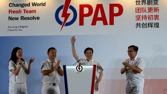 Singapore Prime Minister Lawrence Wong of the Peoples Action Party (PAP) waves to supporters as he celebrates at the partys gathering centre during the general election results, in Singapore on May 3, 2025. Singapores ruling party headed for a crushing victory at general elections on May 3, sample counts showed, with voters giving Prime Minister Lawrence Wong the clear mandate he was seeking. (Photo by Roslan RAHMAN / AFP)