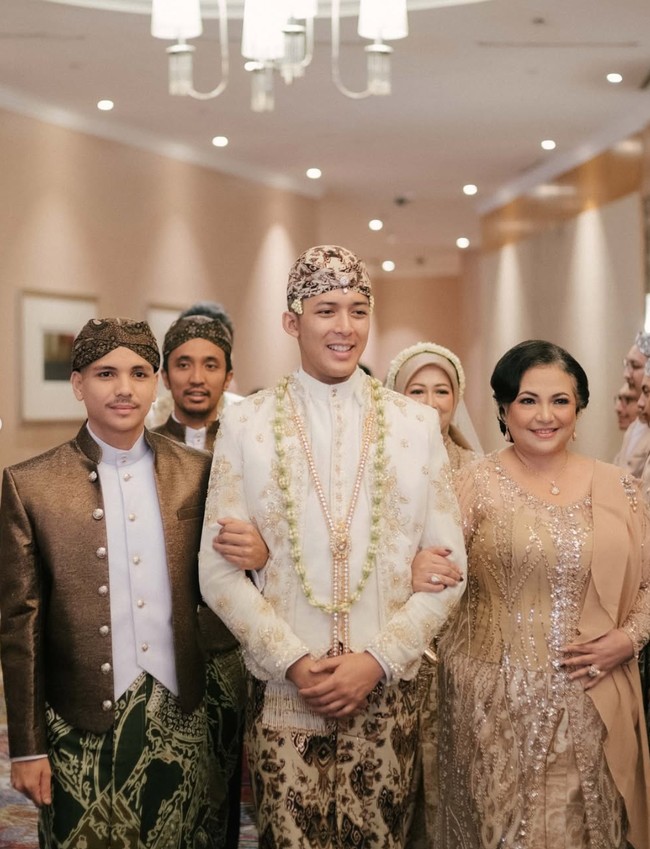 Mochammad Andhika tampil gagah kenakan beskap putih gading dengan detail bordir dan payet. Penampilannya dipadukan dengan kain jarik motif batik dengan dominasi warna coklat serta blangkon senada. Foto: Instagram/@valtifanka