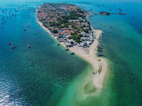 Wisatawan bermain air di tepi pantai Pulau Gili Ketapang, Kabupaten Probolinggo, Jawa Timur, Minggu (4/5/2025). Pulau dengan luas sekitar 68 hektare yang termasuk Kawasan Konservasi Perairan Daerah (KKPD) dengan kategori taman wisata perairan tersebut menawarkan panorama pasir putih serta sejumlah fasilitas paket wisata seperti transportasi, alat selam, wahana banana boat, hingga sajian kuliner ikan laut. ANTARA FOTO/Irfan Sumanjaya/tom.