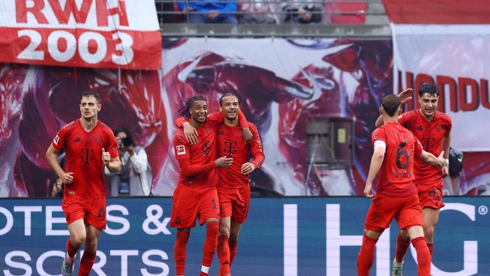 Soccer Football - Bundesliga - RB Leipzig v Bayern Munich - Red Bull Arena, Leipzig, Germany - May 3, 2025 Bayern Munichs Leroy Sane celebrates scoring their third goal with Michael Olise REUTERS/Lisi Niesner DFL REGULATIONS PROHIBIT ANY USE OF PHOTOGRAPHS AS IMAGE SEQUENCES AND/OR QUASI-VIDEO.