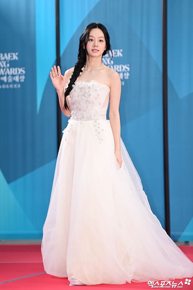 Bak Disney Princess. Hyeri menghadiri ajang penghargaan Baeksang Arts Awards 2025 dengan tatanan rambut fishtail braid menyamping. Dia memakai gaun tulle putih beraksen bunga-bunga yang menyapu lantai. Foto: Instagram
