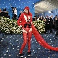 Pada Met Gala 2025 yang mengusung tema “Superfine: Tailoring Black Style,” Amelia Gray Hamlin tampil mencolok dengan busana merah menyala rancangan Valentino. Amelia mengenakan bodysuit renda berwarna dan jaket tuxedo cropped. Foto: AFP/ANGELA WEISS