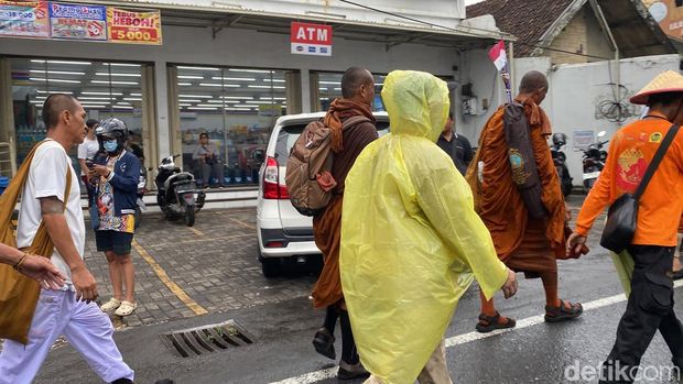 Para biksu thudong kembali melanjutkan perjalanan di tengah hujan, di Jalan Perintis Kemerdekaan, Kelurahan Pudak Payung, Kecamatan Banyumanik, Kota Semarang, Rabu (7/5/2025).