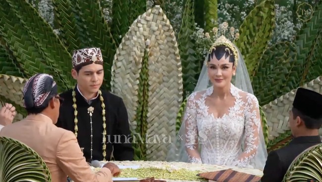 Melengkapi penampilannya Luna memilih mengenakan veil panjang menyapu lantai. Rambutnya tampak rapi tersanggul dengan berhias ronce melati, 5 buah cunduk mentul, serta paes ageng khas pengantin Yogyakarta. Foto: YouTube/Luna Maya