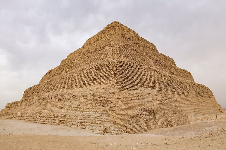 GIZA, EGYPT - MAY 4: Tourists ride on camels as Zoser Pyramid is seen behind at the historical Saqqara region, which is home to the majority of historical artifacts from ancient Egypt, in Giza, Egypt on May 4, 2025. King tombs, temples, small pyramids and the region, where the Zoser Pyramid, which is estimated to have been built in the 2700 B.C. is located, considered an open-air museum. (Photo by Nurettin Boydak/Anadolu via Getty Images)