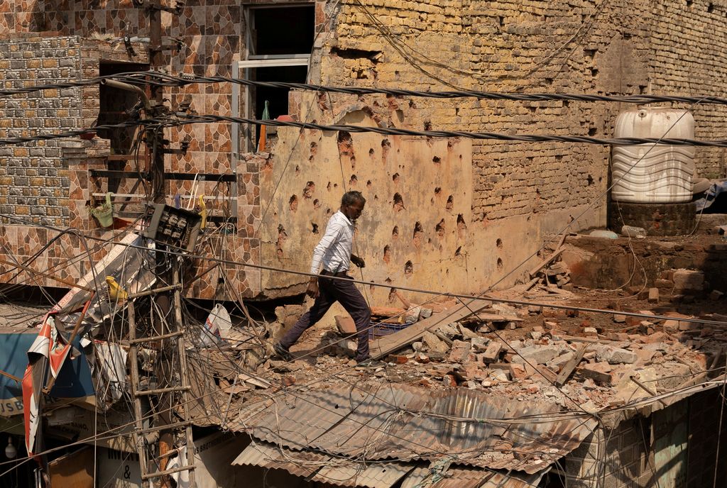 A man walks amidst debris on the roof of a damaged house, following Pakistan's military operation against India, in Rehari, Jammu, May 10, 2025. REUTERS/Adnan Abidi     TPX IMAGES OF THE DAY