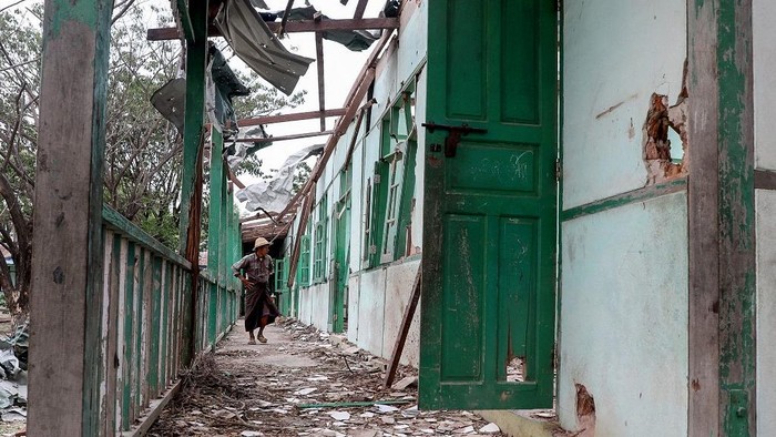 A man looks inside a school building damaged in a bombardment carried out by Myanmars military at the Ohe Htein Twin village in Tabayin township, Sagaing Region, on May 12, 2025. A Myanmar junta airstrike hit a school on May 12 killing 22 people, including 20 children, witnesses said, despite a purported humanitarian ceasefire called to help the nation recover from a devastating earthquake. (Photo by AFP)