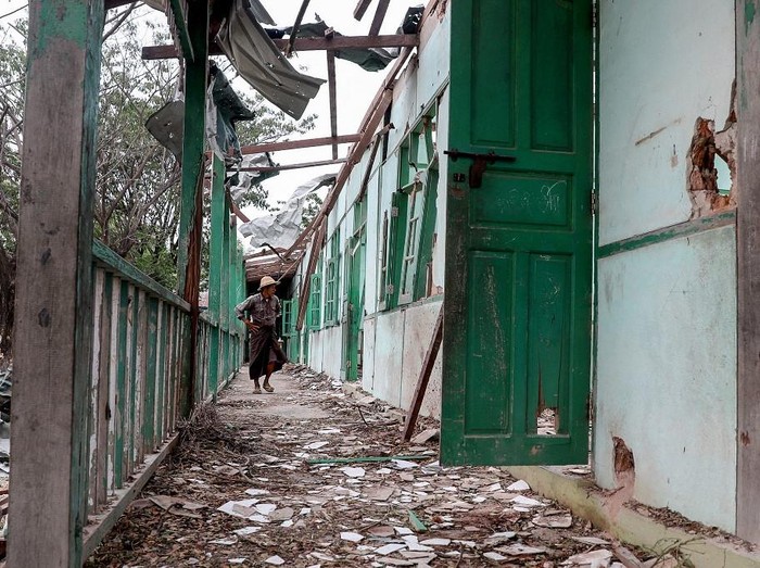 A man looks inside a school building damaged in a bombardment carried out by Myanmars military at the Ohe Htein Twin village in Tabayin township, Sagaing Region, on May 12, 2025. A Myanmar junta airstrike hit a school on May 12 killing 22 people, including 20 children, witnesses said, despite a purported humanitarian ceasefire called to help the nation recover from a devastating earthquake. (Photo by AFP)