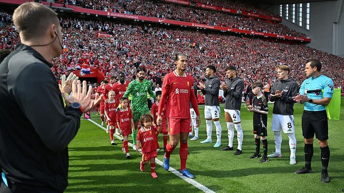 LIVERPOOL, ENGLAND - MAY 11:  (SUN OUT, SUN ON SUNDAY OUT) Virgil van Dijk of Liverpool leads the team out, as players of Arsenal and the match officials form a guard of honour prior to the Premier League match between Liverpool FC and Arsenal FC at Anfield on May 11, 2025 in Liverpool, England. (Photo by Liverpool FC/Liverpool FC via Getty Images)