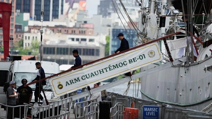 People disembark the Mexican Navy training vessel Cuauhtemoc while it's docked at a pier, after striking the Brooklyn Bridge overnight in New York City, U.S., May 18, 2025.  REUTERS/Eduardo Munoz