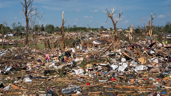 David and Edwina Wilson look on as a clean up crew removes parts of their destroyed home in the Sunshine Hills neighborhood after a series of tornadoes hit Laurel County, in London, Kentucky, U.S. May 18, 2025.  REUTERS/Seth Herald