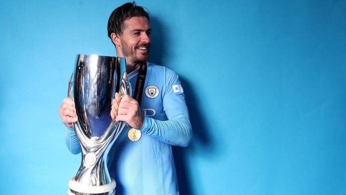 PIRAEUS, GREECE - AUGUST 16: Jack Grealish of Manchester City poses with the Super Cup Trophy at the winners shoot after winning the UEFA Super Cup 2023 match between Manchester City FC and Sevilla FC at Karaiskakis Stadium on August 16, 2023 in Piraeus, Greece. (Photo by Alexander Hassenstein - UEFA/UEFA via Getty Images)