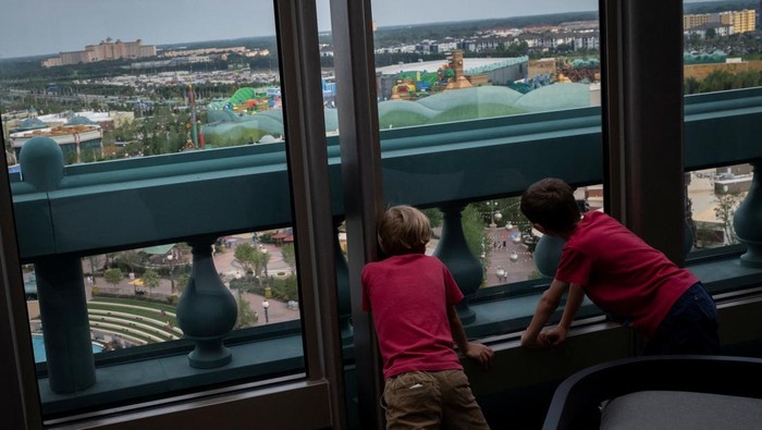 Children look at Universal Epic Universe theme park from a restaurant at the roof of the Universal Helios Grand Hotel ahead of the grand opening ceremony in Orlando, Florida, U.S. May 19, 2025. REUTERS/Marco Bello