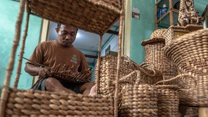 Kerajinan eceng gondok kualitas ekspor di Banyubiru Perajin kerajinan tanaman eceng gondok (Eichornia crassipes) yang tergabung dalam Klaster Perajin Eceng Gondok Klinting, Slamet menyelesaikan cendera mata di rumah produksinya Renita Eceng Gondok, Banyubiru, Kabupaten Semarang, Jawa Tengah, Rabu (21/5/2025). Produksi berbagai macam cendera mata seperti tas, topi, sepatu, miniatur, dan furnitur berbahan eceng gondok seharaga Rp45 ribu - Rp 3,5 juta per unit itu dipasarkan ke sejumlah wilayah di Indonesia, dan telah menembus pasar Belanda dan Singapura. ANTARA FOTO/Aji Styawan/bar