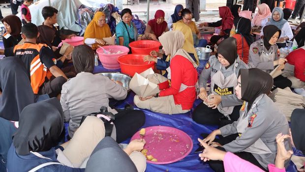 Polwan Polres Grobogan saat memberikan trauma healing kepada anak-anak korban banjir dan menyiapkan logistik di dapur umum di Desa Tanggirejo, Kecamatan Tegowanu. Foto diunggah Kamis (22/5/2025).