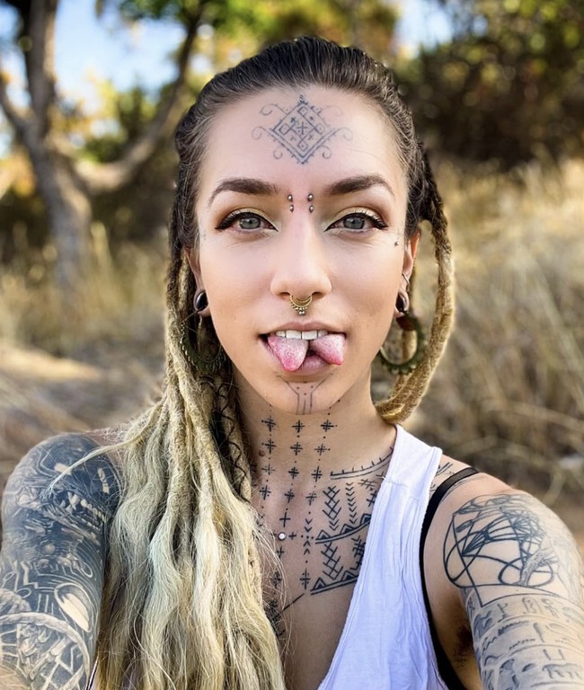 Kemudian berkembang menjadi tato dada besar yang menjalar hingga ke leher, tato di kaki, wajah, tangan, serta penggunaan spacer di telinga, tindik di  hidung, dan lidah terbelah. Foto: dok. Instagram @flower.friendly