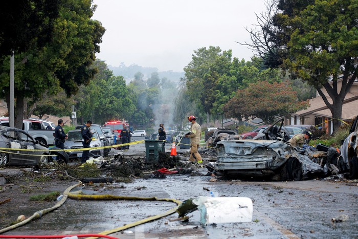 A view shows a damage house and vehicle at the crash scene, after a small civilian aircraft went down in a military neighborhood in San Diego, California, U.S. May 22, 2025.  REUTERS/Mike Blake