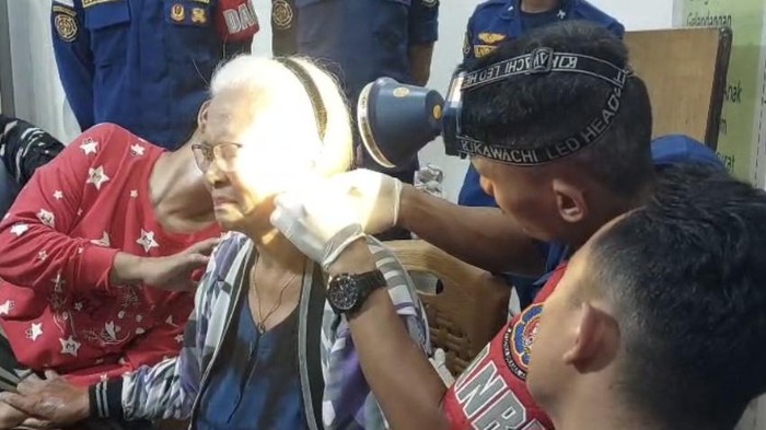 Petugas Damkar saat membantu wanita yang anting-anting di telinga sulit dilepas