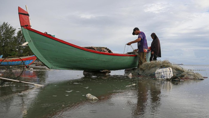 Nelayan merapikan jaring usai menangkap ikan di pesisir pantai Ujong Pancu, Lam Awe, Aceh Besar, Aceh, Sabtu (24/5/2025). Nelayan tradisional di kawasan tersebut masih mengandalkan perahu kecil dan jaring untuk menangkap ikan di jarak 200-500 meter dari bibir laut. ANTARA FOTO/Khalis Surry/bar